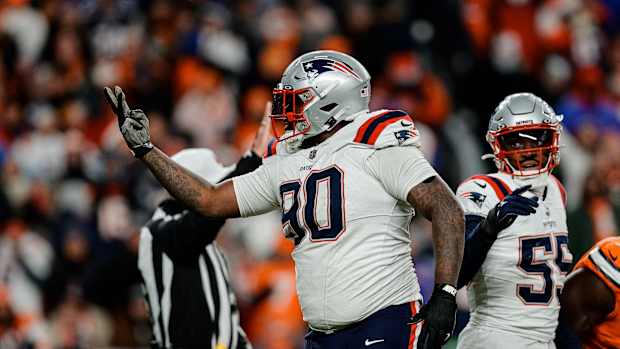 New England Patriots defensive tackle Christian Barmore (90) reacts after a play ]in the third quarter against the Denver Broncos at Empower Field at Mile High.